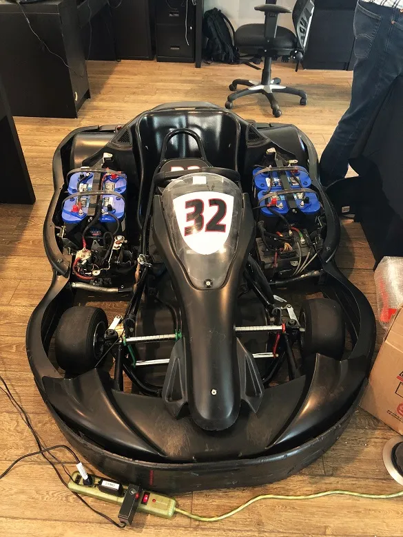 The electrical components of a miniature racecar prototype are tested by MAKO's team to ensure optimal functionality.